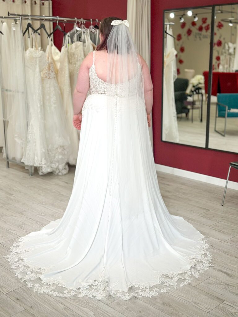 bride wearing off the rack budget friendly plus size chiffon beach wedding dress in los angeles area bridal shop