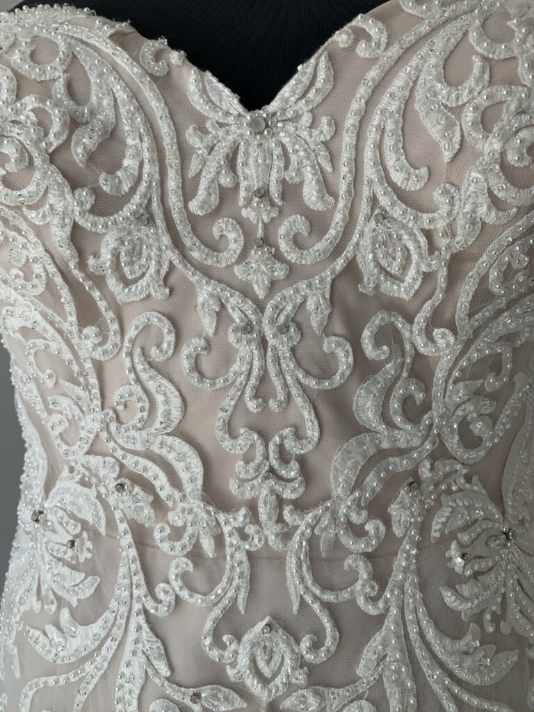 close up of lace wedding dress with pearls