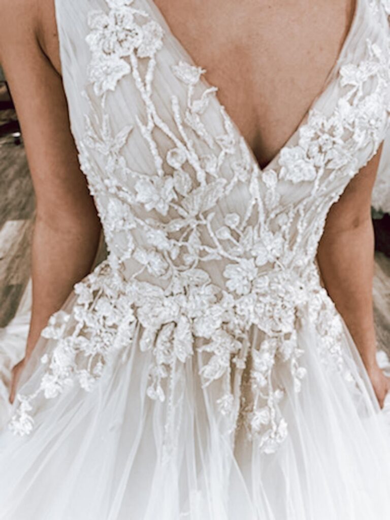 close up of vneck couture textured lace and tulle ballgown wedding dress