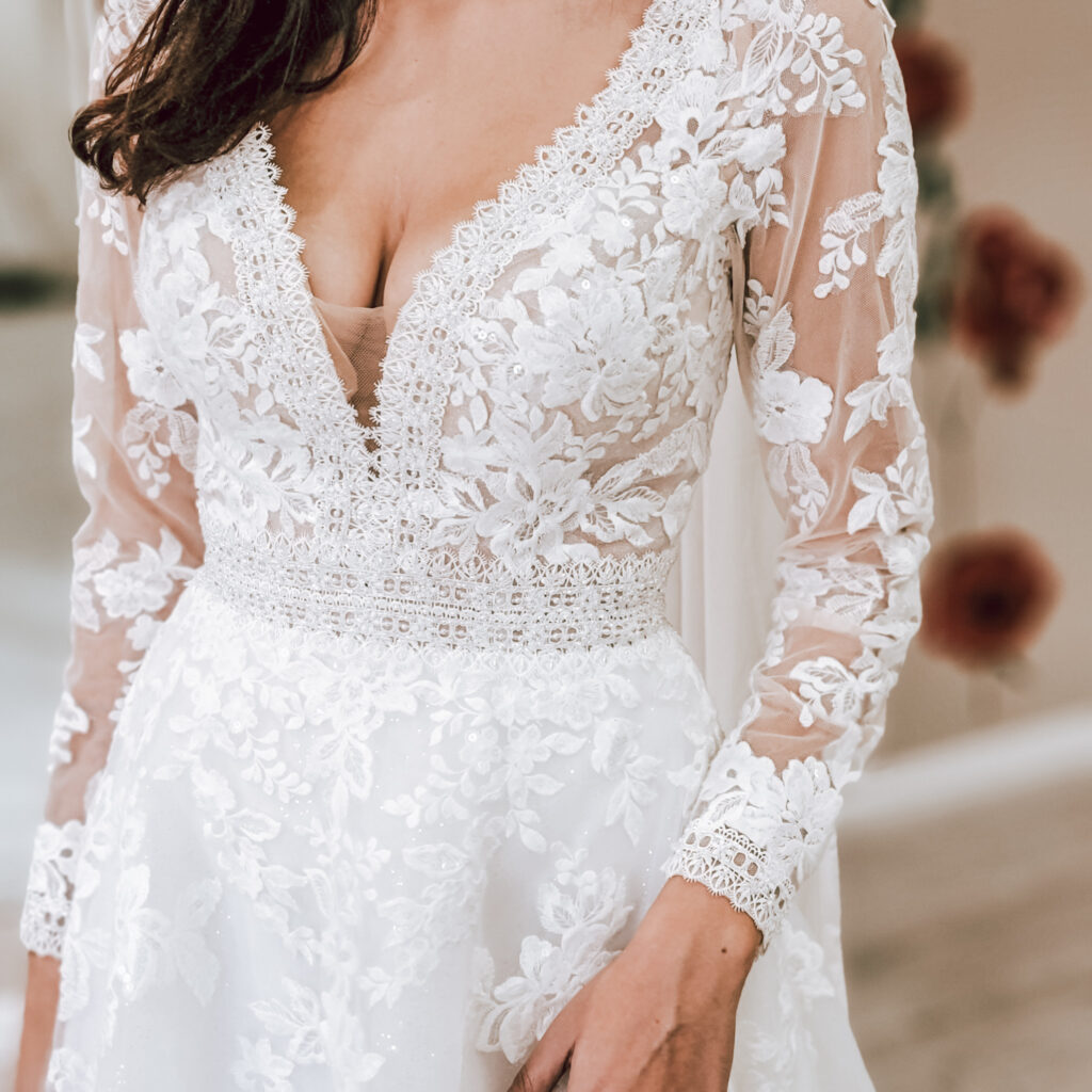 vneck lace long sleeve aline wedding dresses in bridal store los angeles california