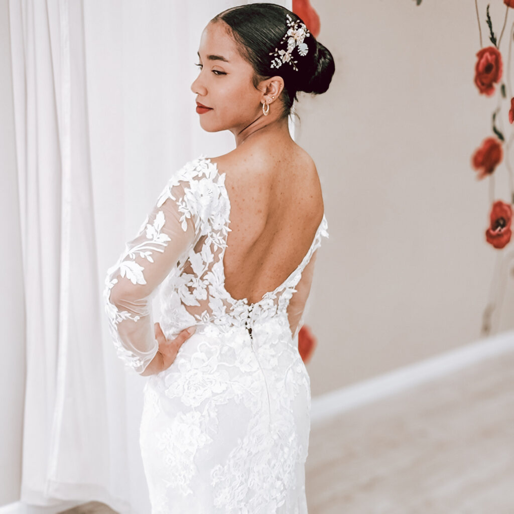petite bride wearing low back lace long sleeve wedding dress in whittier california