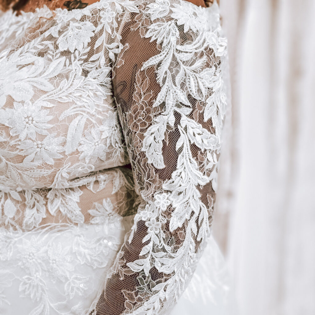 long sleeve lace wedding dress close up on plus size body in whittier california