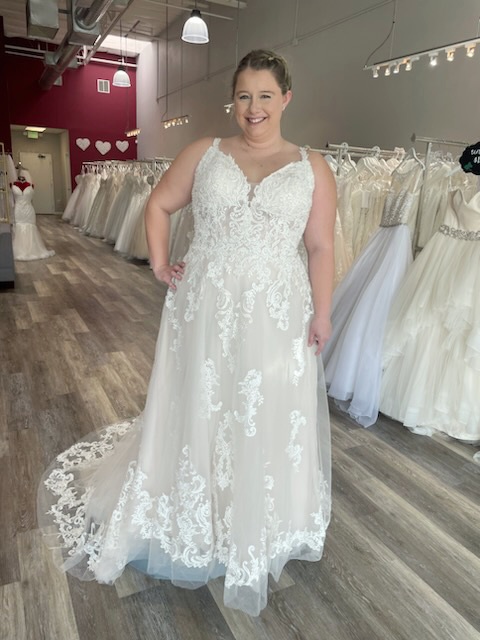 plus size bride wearing sparkly aline wedding dress in hayward california bridal shop