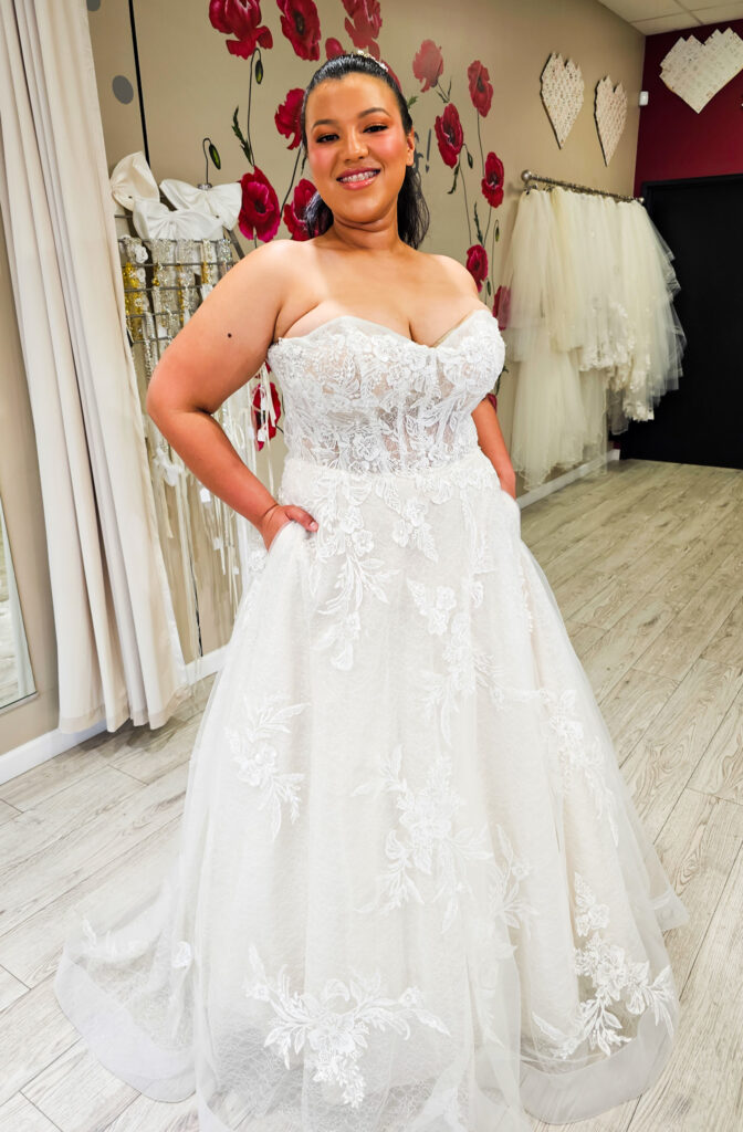 plus size bride wearing floral aline wedding dress in whittier california bridal shop