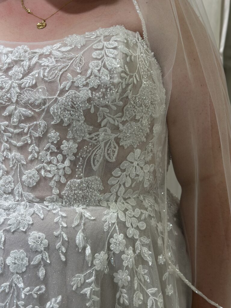 close up of plus size wedding dress with corset and lace