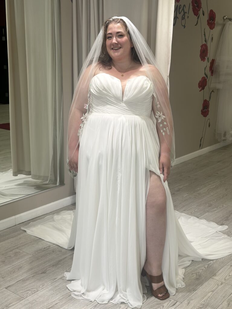 woman wearing flowy plus size wedding dress with a slit