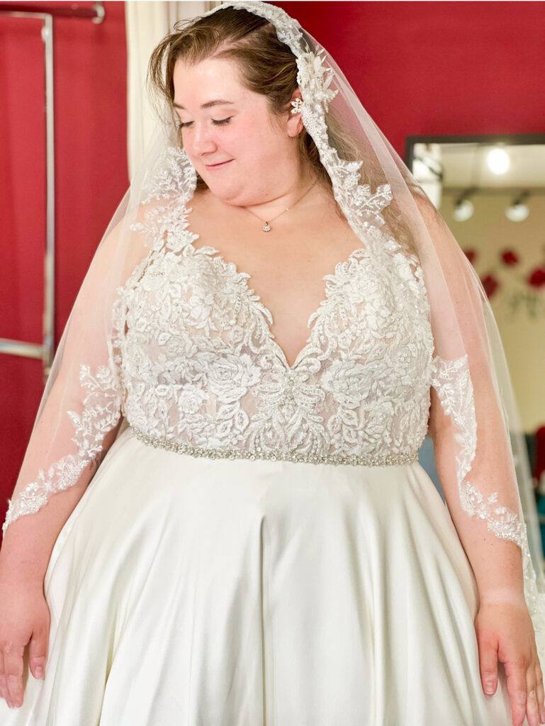 dark ivory winter wedding dress on plus size bride with lace veil