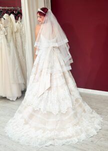 plus size bride wearing wedding dress in an affordable bridal shop in los angeles california