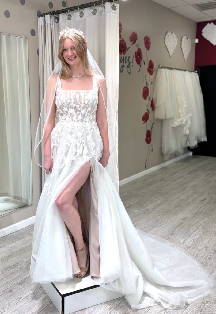 bride wearing square neckline wedding dress in off the rack bridal store whittier california