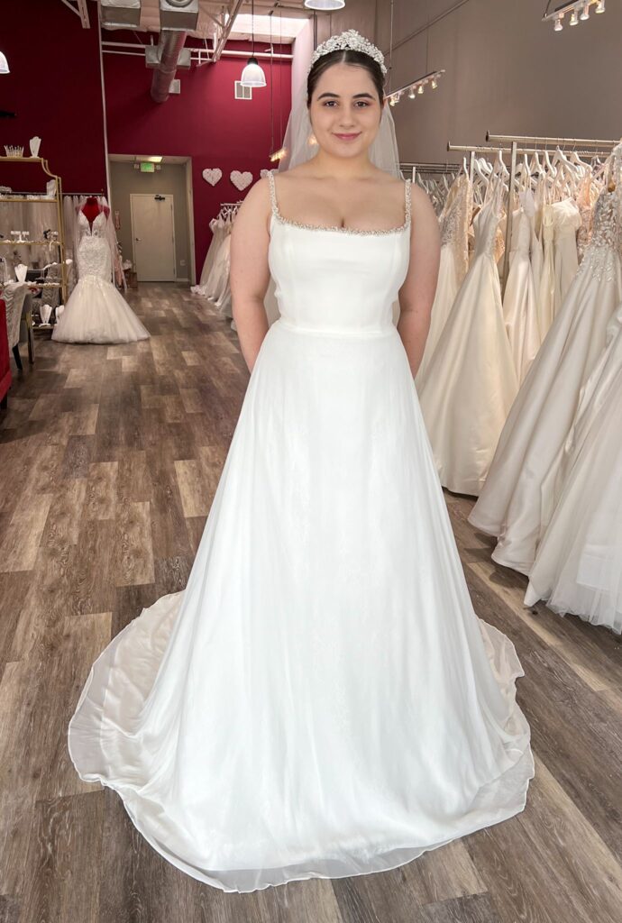 bride wearing square neckline wedding dress in off the rack bridal store Hayward california